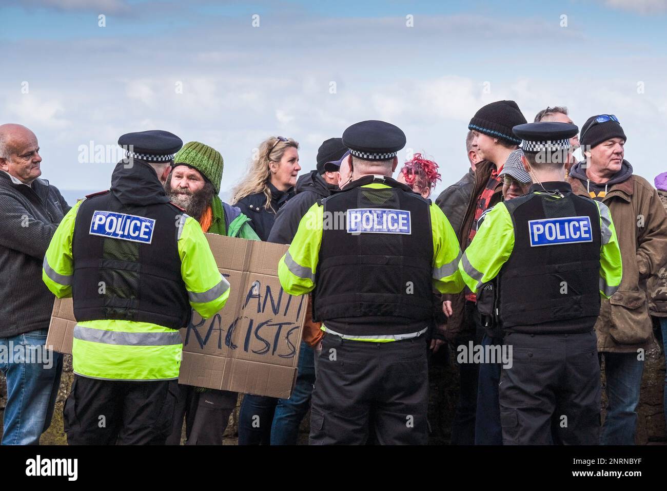 Agentes de policía de Devon y Cornwall hablando con personas que protestaban contra los solicitantes de asilo que se alojan en el Hotel Beresford en Newquay en Cornwall, Reino Unido Foto de stock