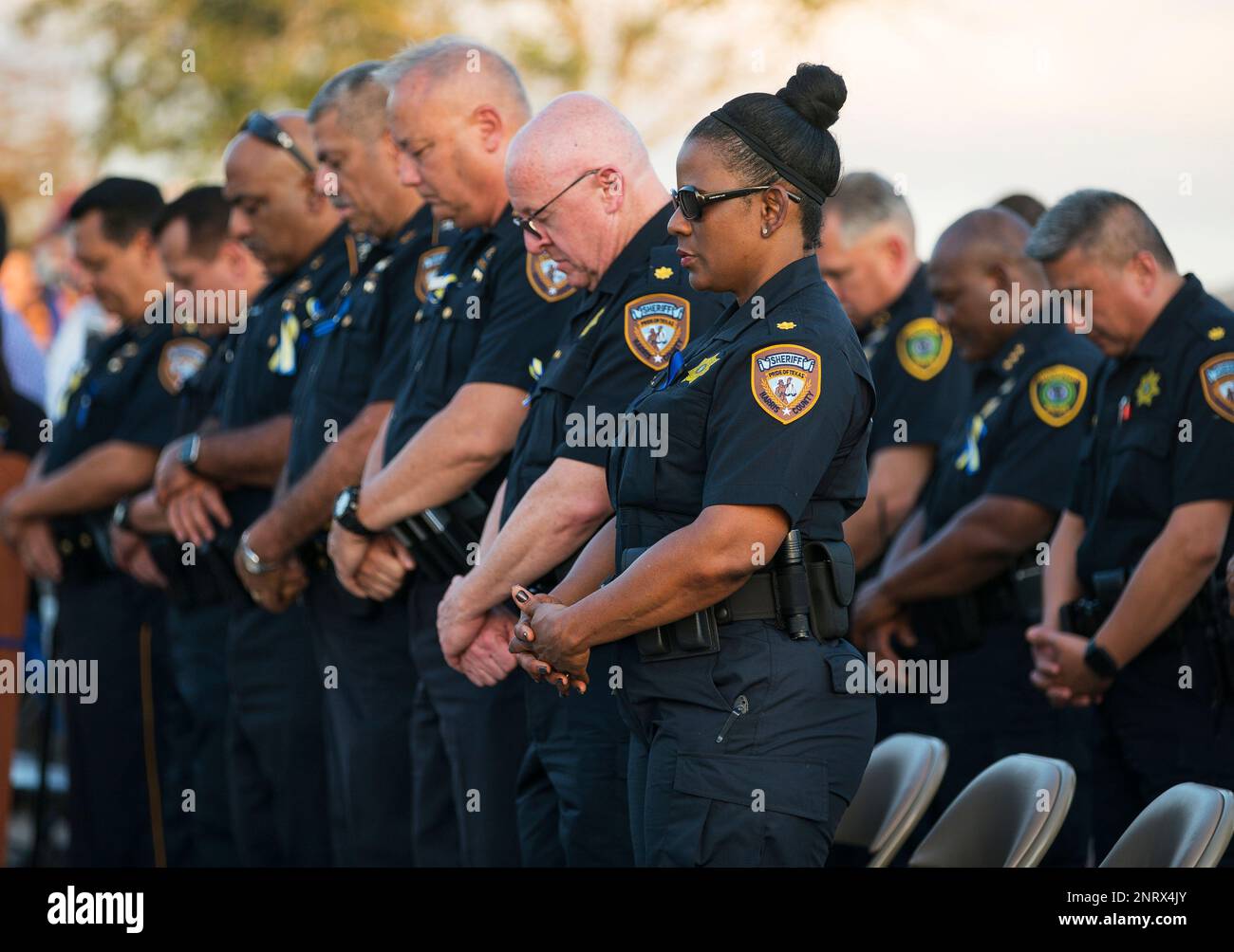 Harris County Sheriff's Office deputies bow their heads in prayer