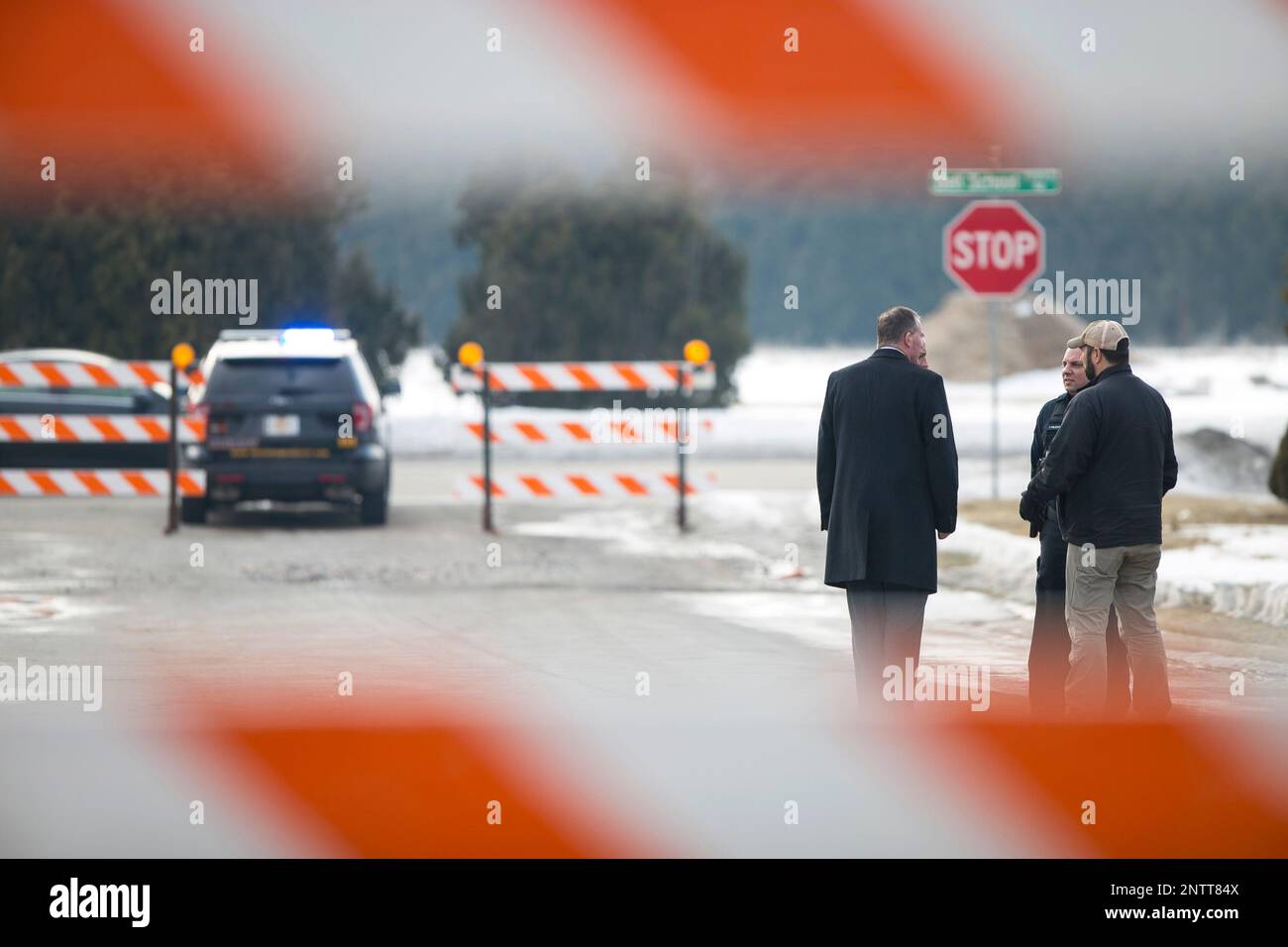 Crime scene investigators stand outside at the Extended Stay America