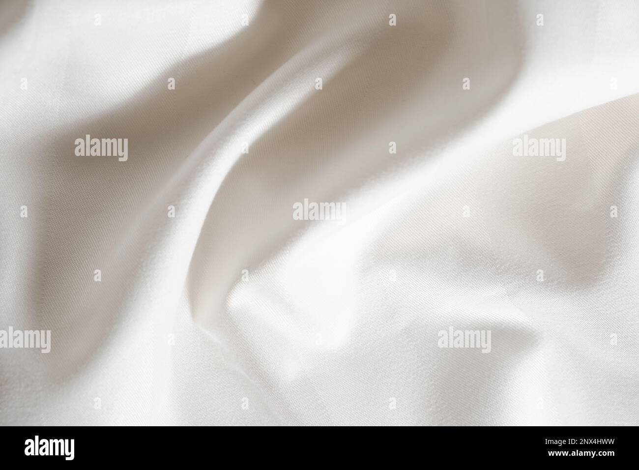 Mantel de lino textil de color blanco con hermosos pliegues superficie de  tela como fondo