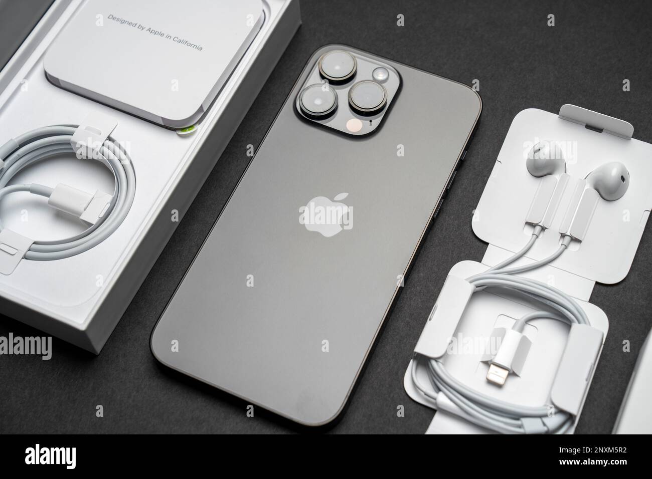 Nuevo iPhone 14 pro max y Apple EarPods, auriculares AirPods blancos para  escuchar música y podcasts en una caja abierta. Fondo negro aislado  Fotografía de stock - Alamy
