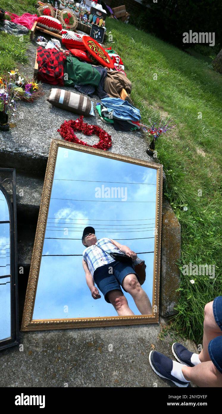 Jackie Dewitt of Strasburg, Va. is reflected in a mirror for sale as
