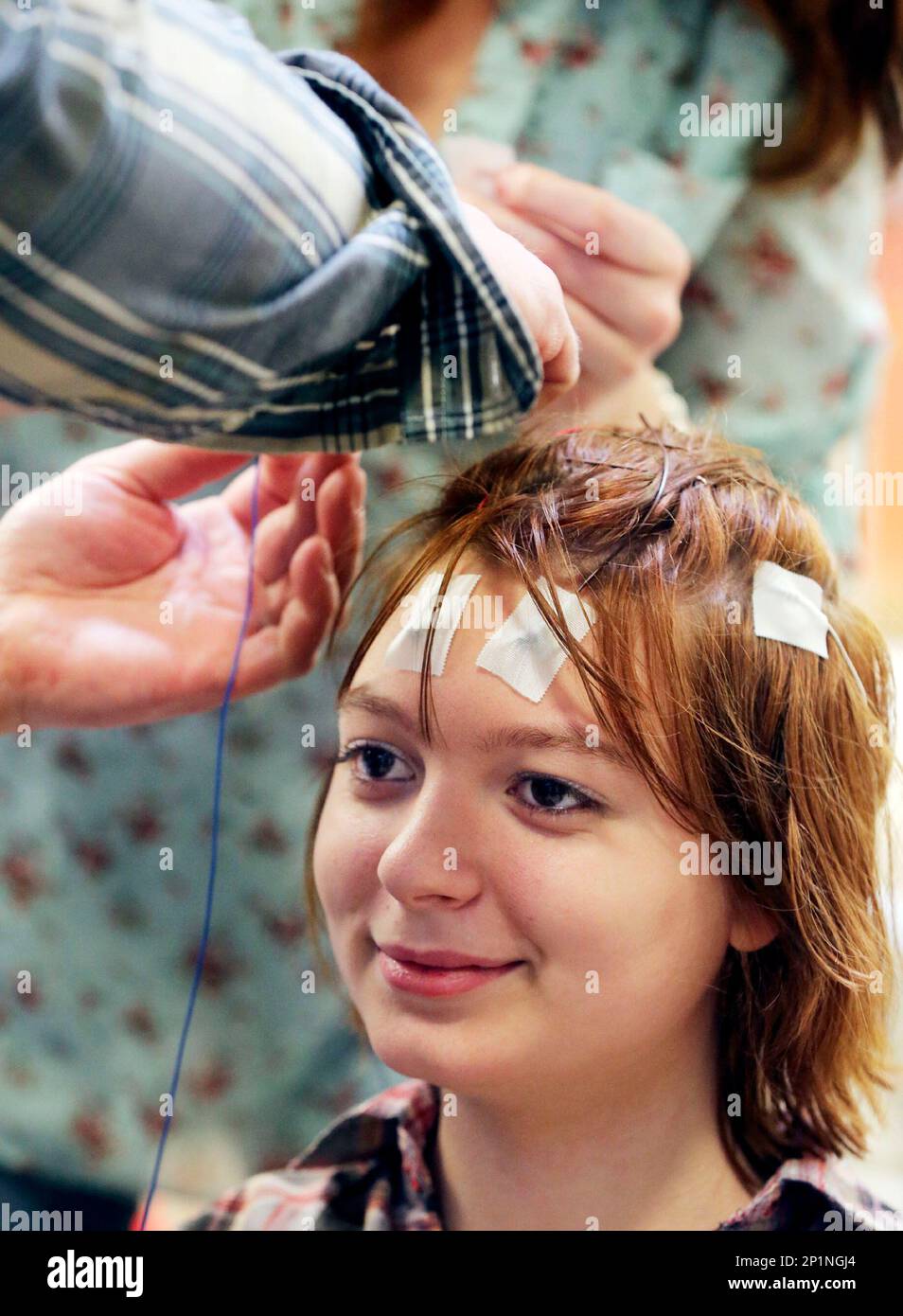Katelyn Allen, 15, waits while neurological diagnostic technicians