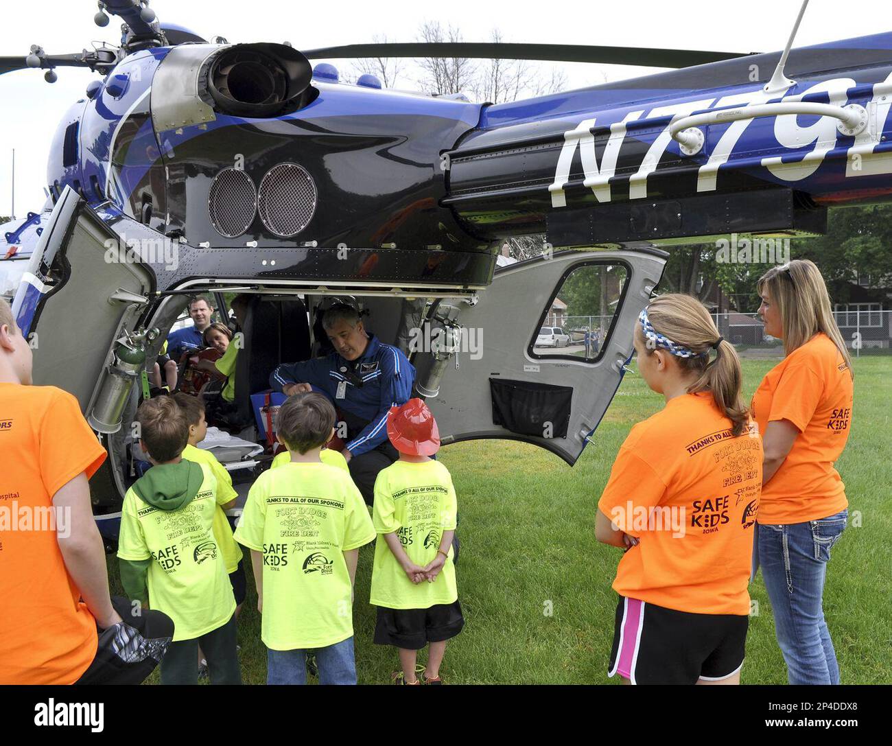 Paramedic Ben Schloss shows a group of children the back doors of the