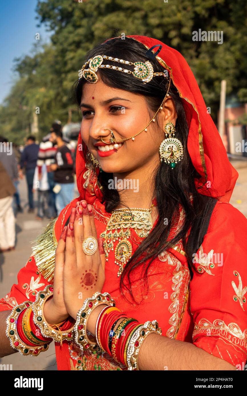 India, Rajastán, Bikaner, Desfile del Festival del Camello, hermosa mujer Rajastán en sari rojo haciendo gesto de Namaste Foto de stock