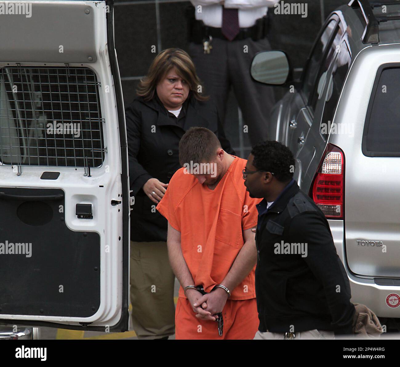 Conrad Alvin Barrett, 27, is escorted out of the Bob Casey Federal