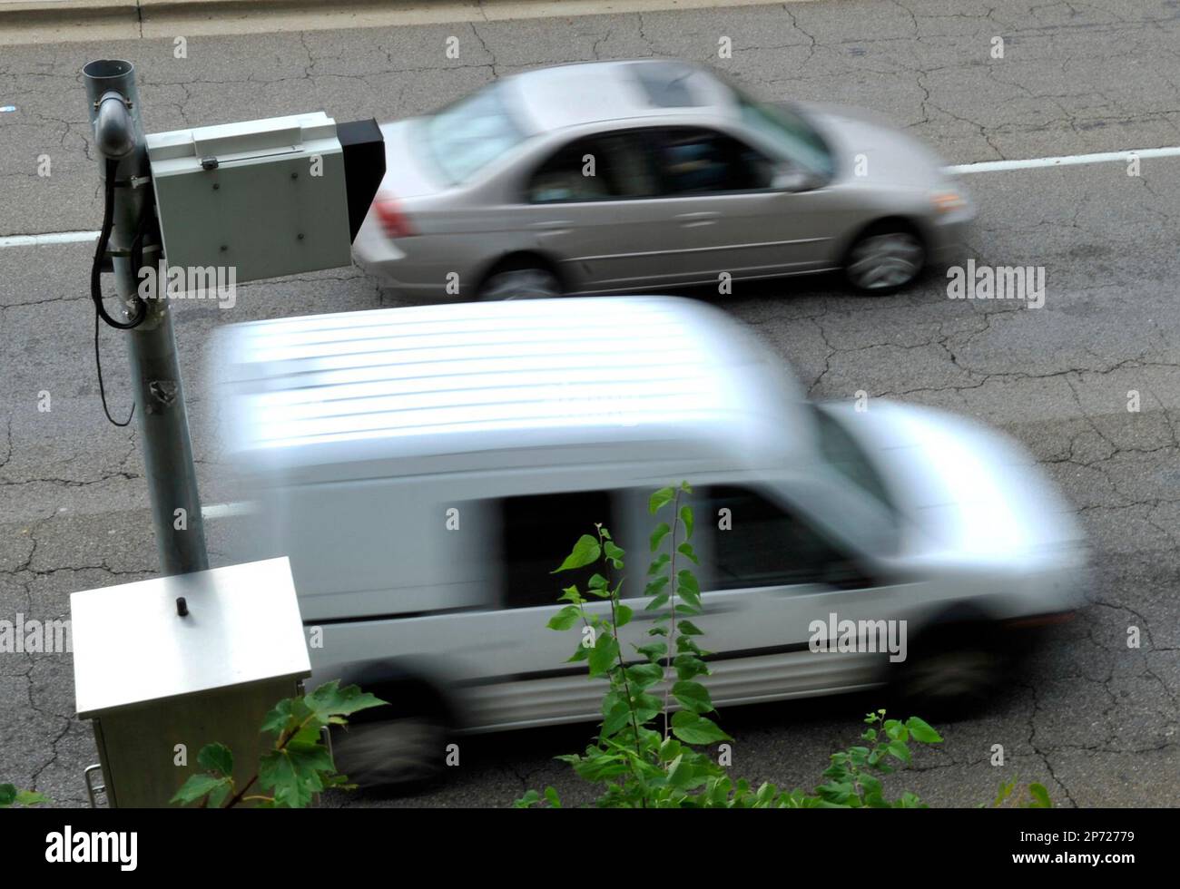 In a Tuesday, Sept. 6, 2011 photograph, traffic moves past a red light