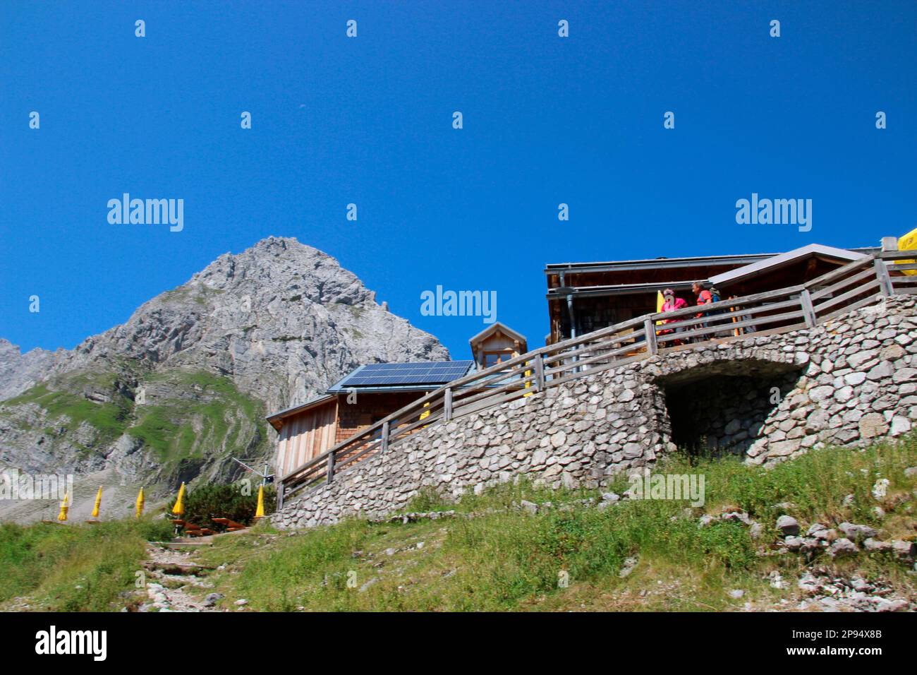 Cabaña Coburger, cabaña DAV, por encima del lago dragón, terraza, cordillera Mieminger, Cabeza de dragón en el fondo, Ehrwald, Tirol, Austria Foto de stock