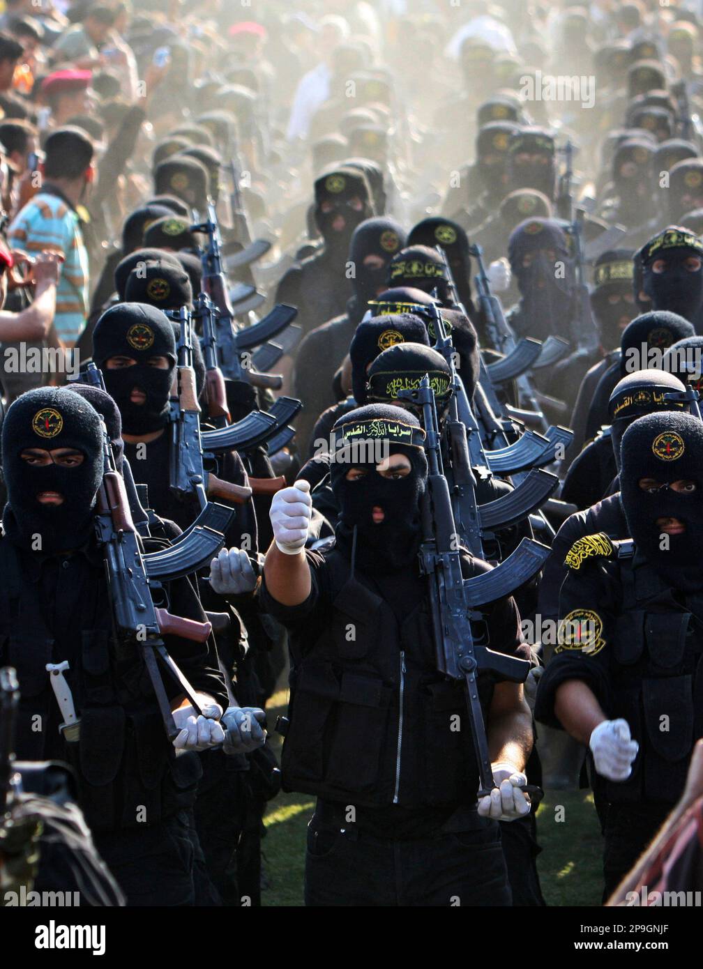 Masked militants of Islamic Jihad march during a rally marking the 13th