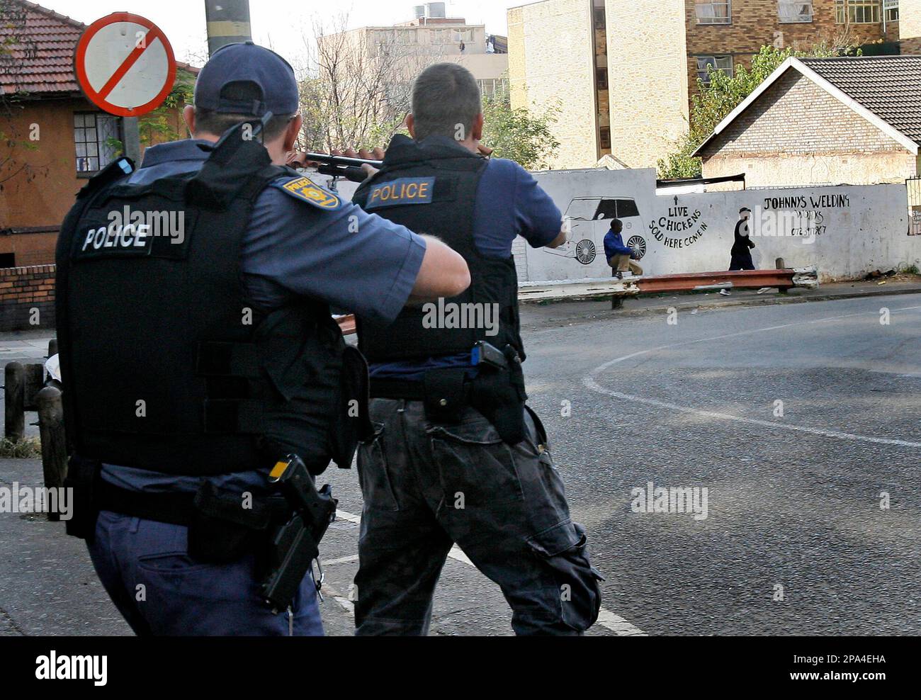 South African police officers use rubber bullets to disperse crowds in Johannesburg, South