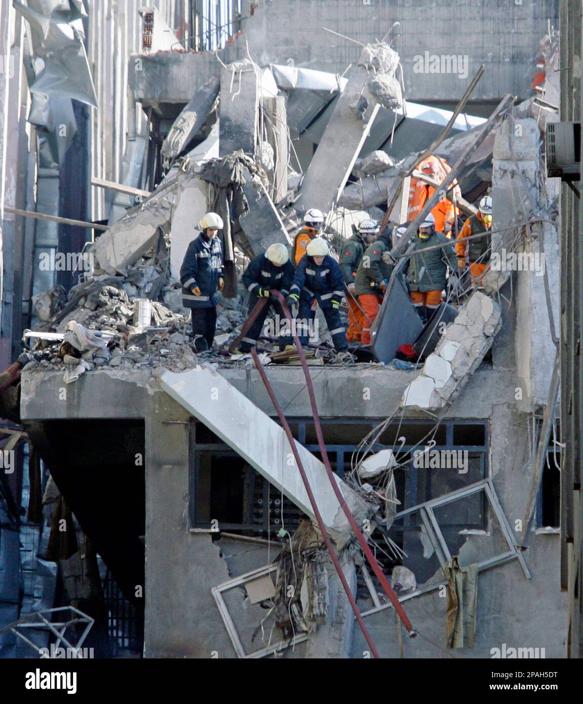 Rescue workers search through rubble for survivors after an explosion