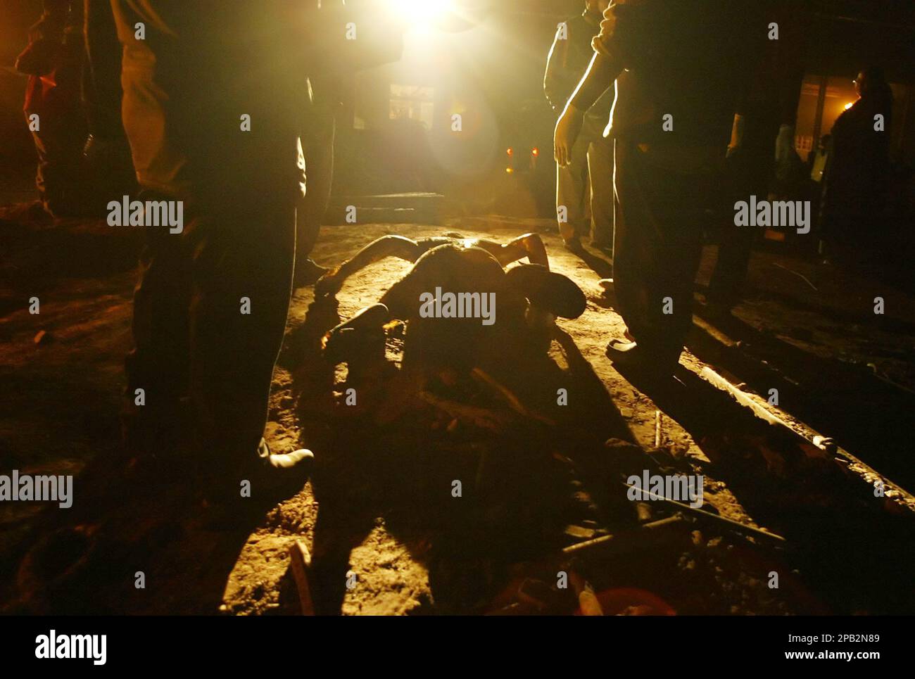 EDS NOTE: GRAPHIC CONTENT ** Rescue workers stand next to a body of a  victim of a furnace explosion at a Kenyan factory on the outskirts of  Nairobi, Kenya on Monday,