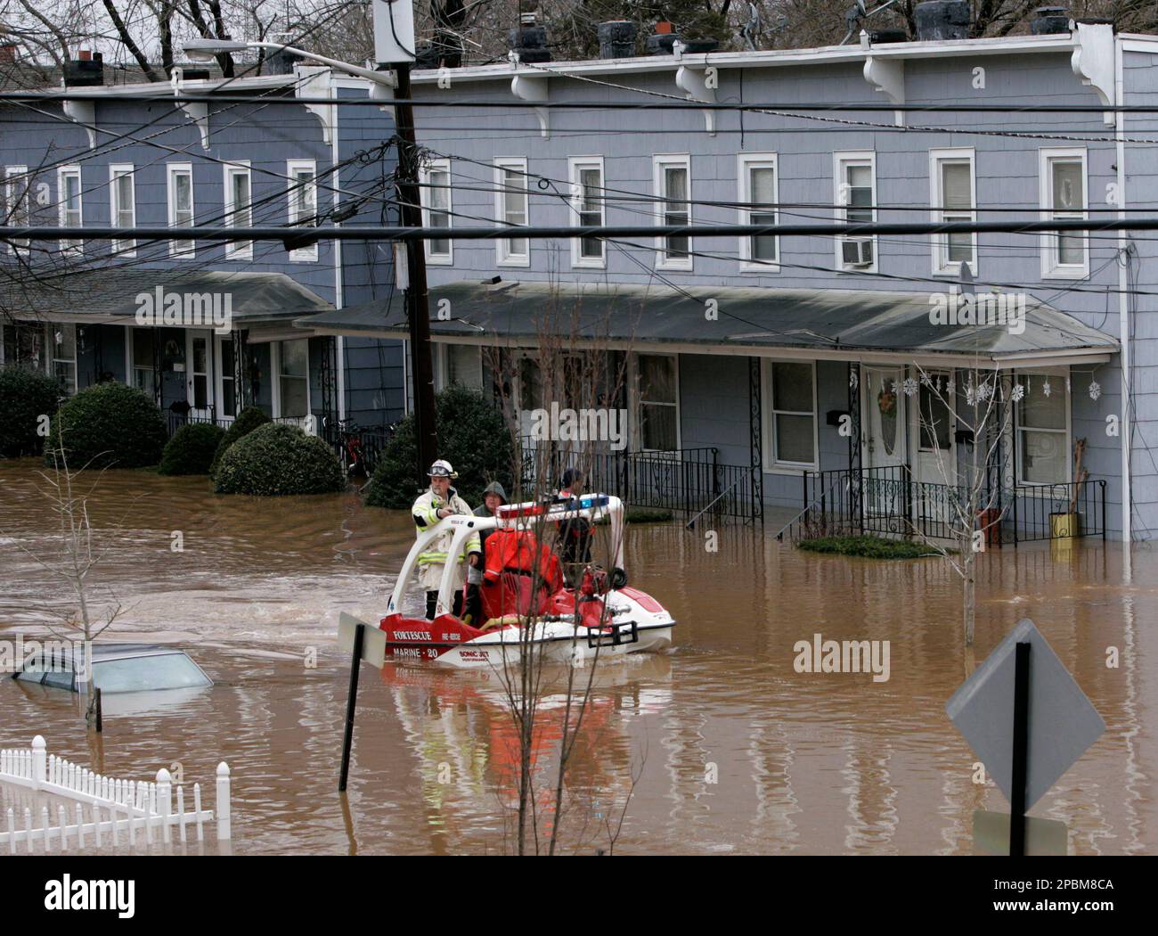 Rescue workers patrol by boat through a flooded neighborhood in Bound