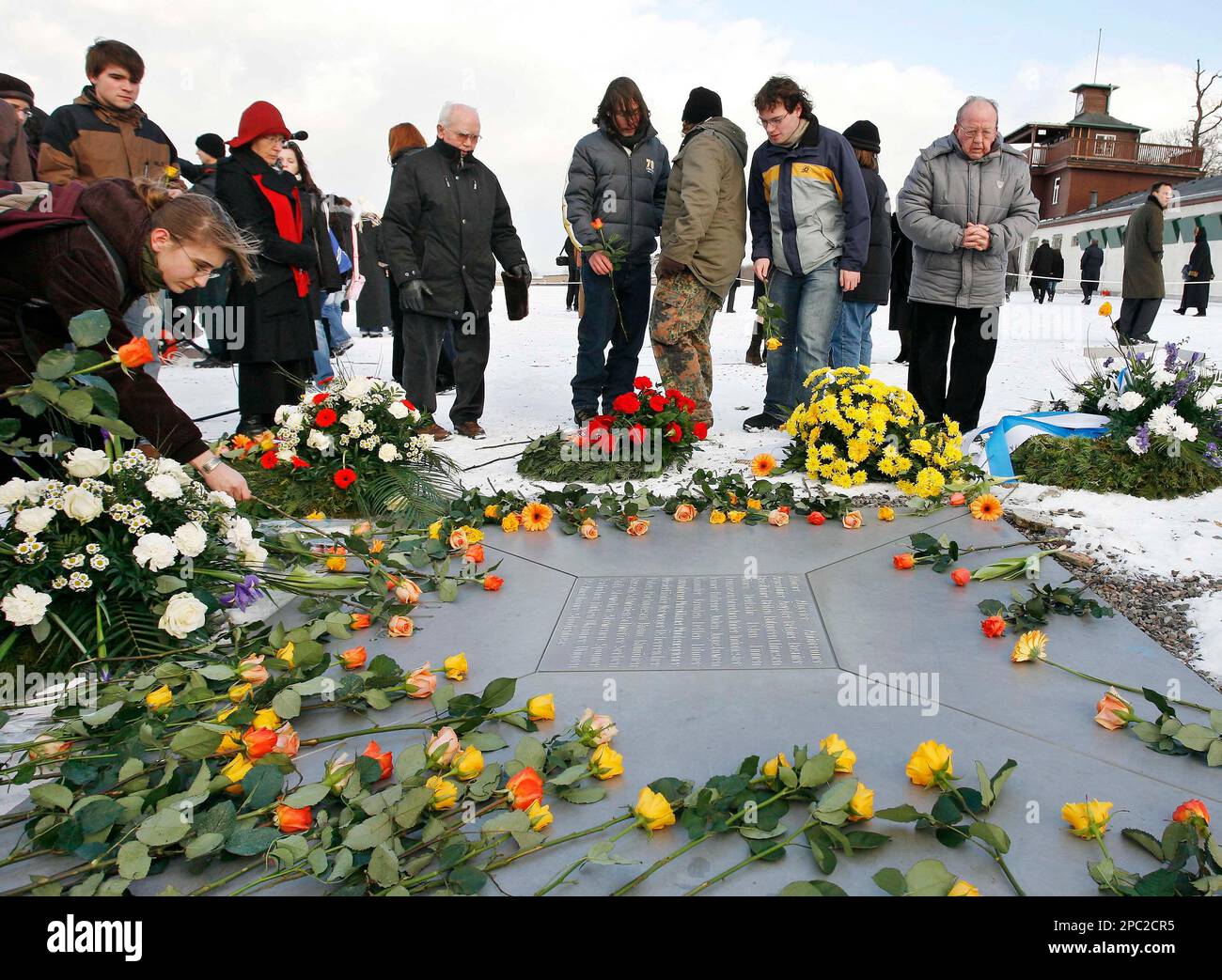 People lay down flowers during the International Day of Commemoration