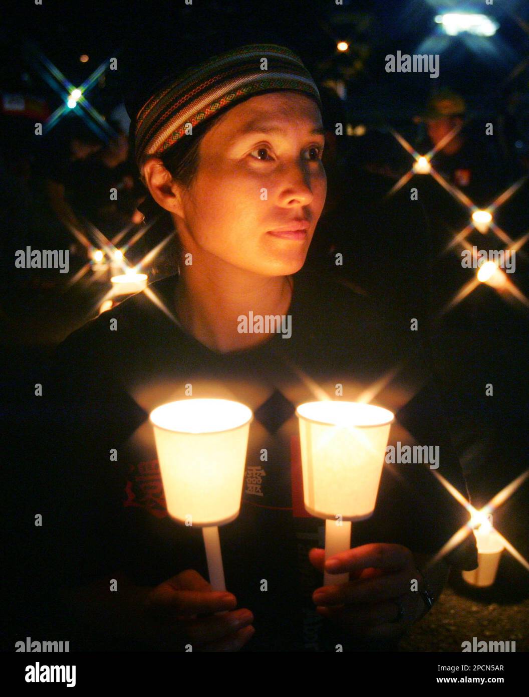 Taiwan's lawmaker Kao Chin Sumei holds lit candles during a