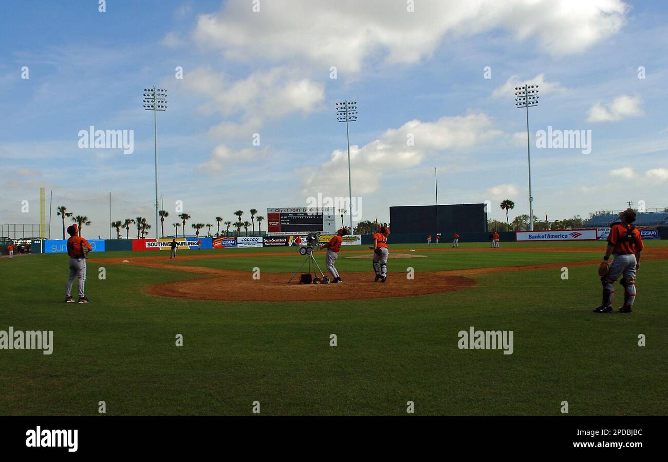 Baltimore Orioles third base coach Tom Trebelhorn, center, and catcher