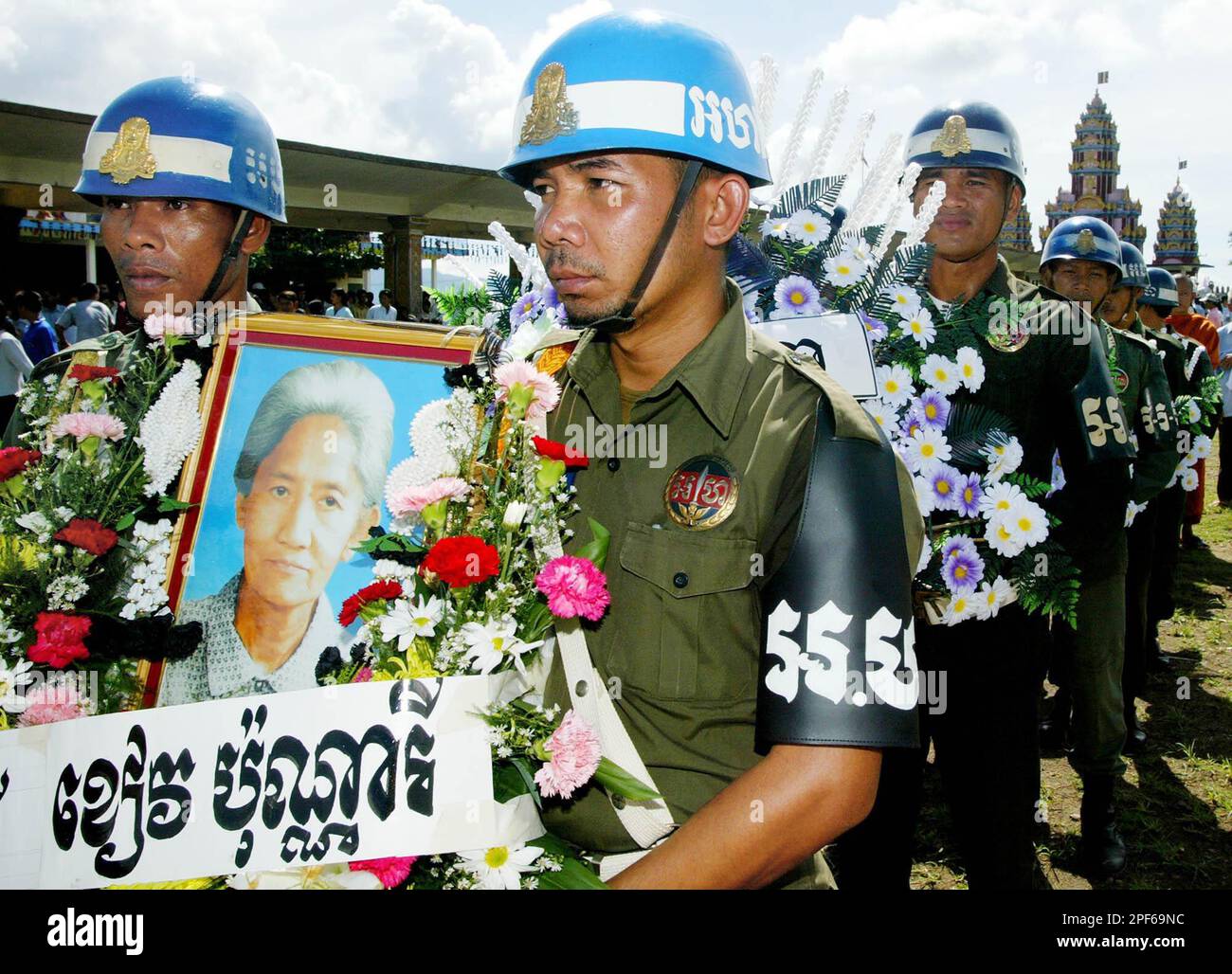 Cambodian military honor guards carry a portrait of Khieu Ponnary, the