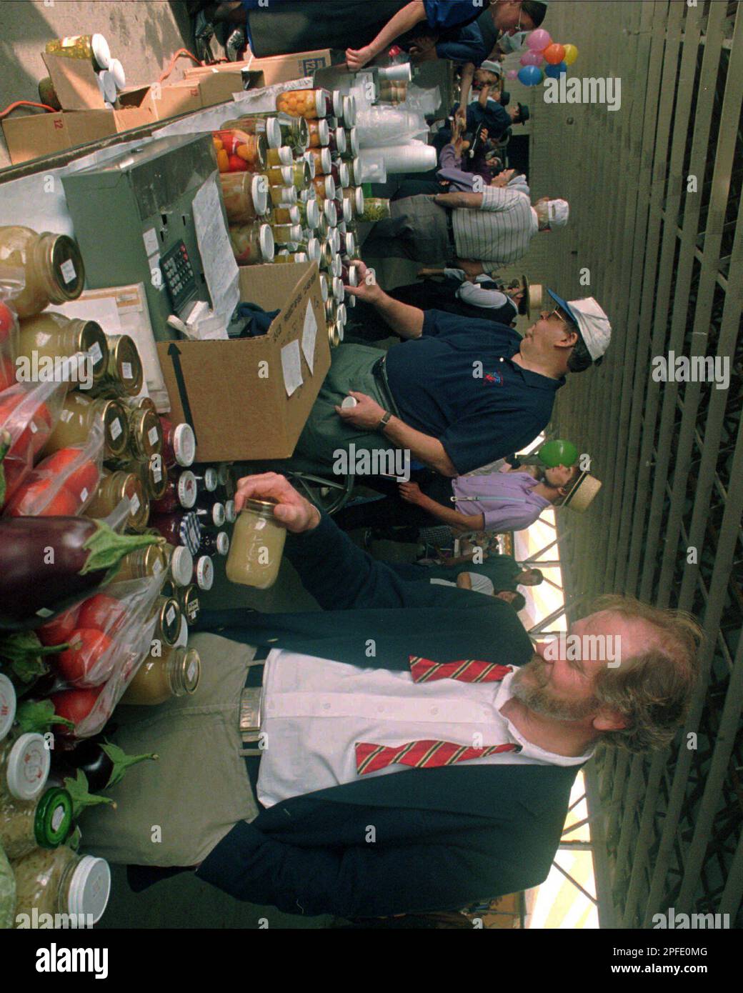 Dr. D. Holmes Morton, foreground, looks at items for sale at the