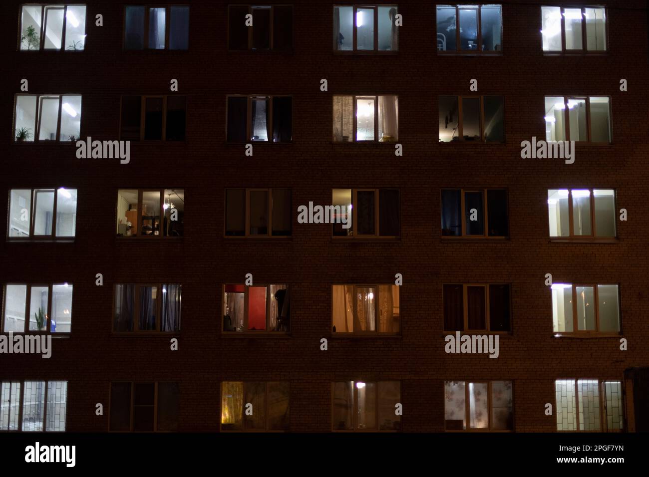 Ventanas en la casa por la noche. Luz de las ventanas de los apartamentos. Foto de stock