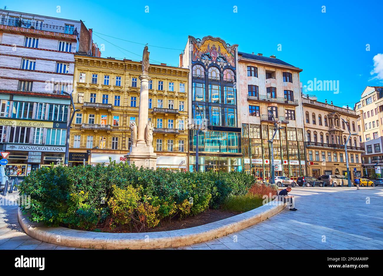 BUDAPEST, HUNGRÍA - 22 DE FEBRERO de 2022: Plaza Szervita con columna de piedra Inmaculada y casas adosadas, incluyendo el Banco Turco ornamentado con decoración de mosaico, en febrero Foto de stock
