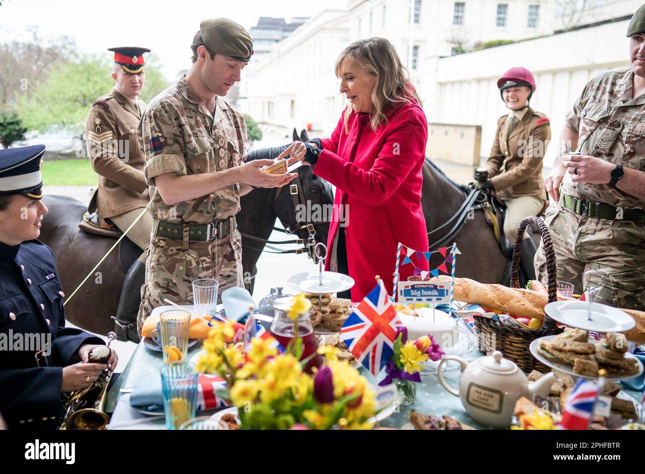 El presentador Mel Geidroyc con miembros de los guardias escoceses y los guardias de Coldstream durante el Gran almuerzo de coronación con militares en Wellington Barracks, Londres. Fecha de la fotografía: Martes 28 de marzo de 2023. Foto de stock