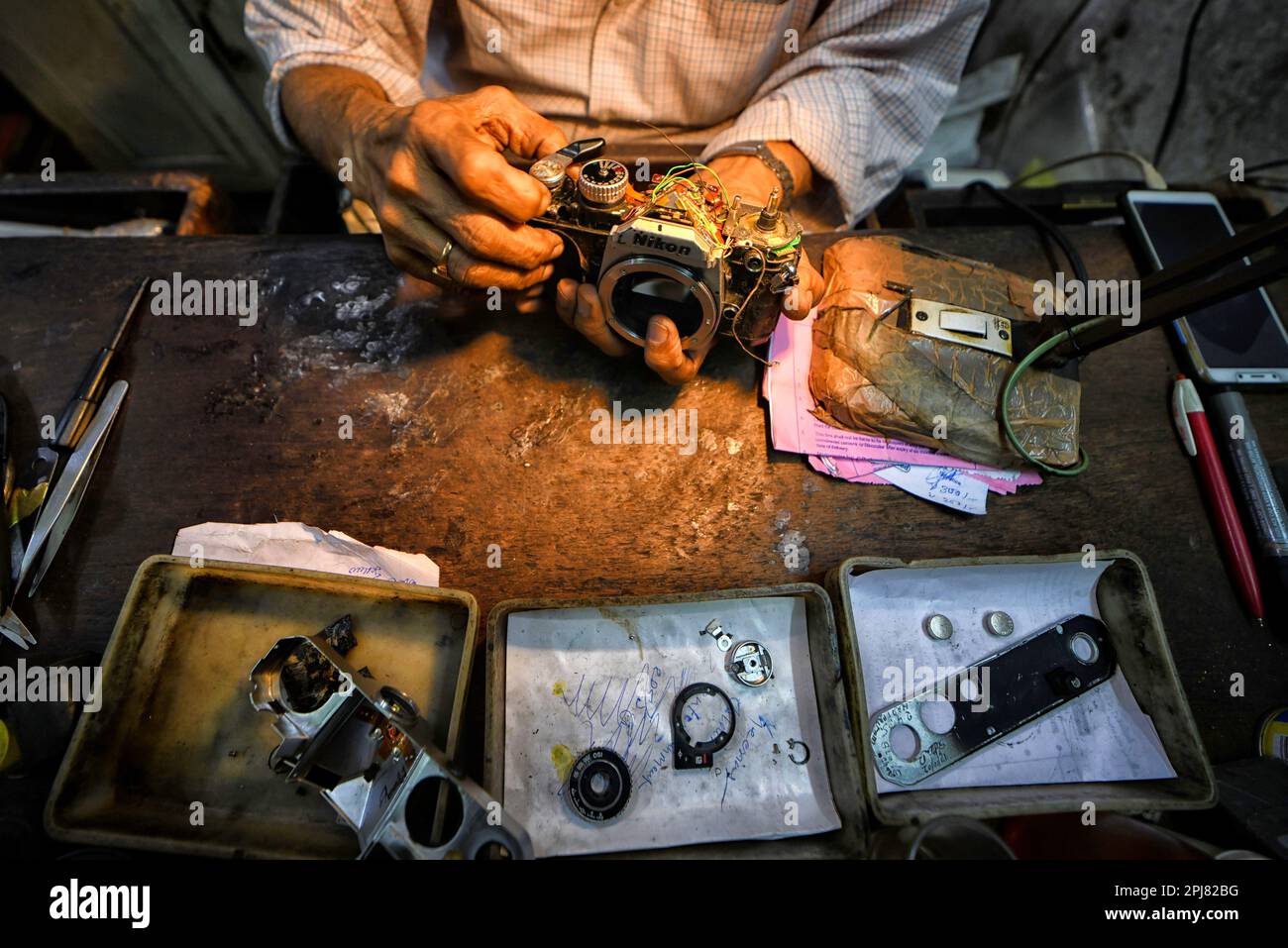 Kolkata, India. 31st de marzo de 2023. Un técnico de cámara repara una  cámara de fotos analógica en su pequeño taller de reparación de cámaras en  Calcuta. S. Samanta & Company, fundada