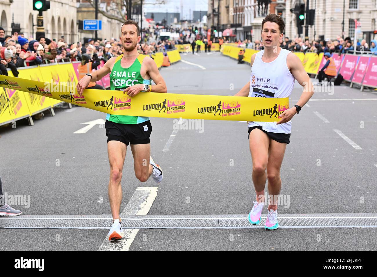 David Smale (izquierda) y Ben Leaman cruzan la línea de meta en la Media Maratón de Londres, organizada por la organización benéfica Tommy's. Fecha de la fotografía: Domingo 2 de abril de 2023. Foto de stock