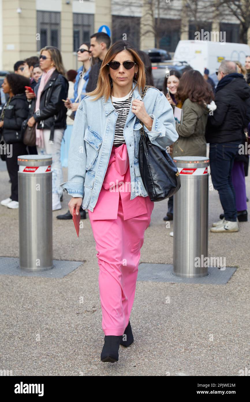 MILÁN, ITALIA - 25 DE FEBRERO de 2023: Alice Barbier con falda rosa y chaqueta vaquera azul claro antes del desfile de Ferragamo, Milan Fashion Week street s Foto de stock