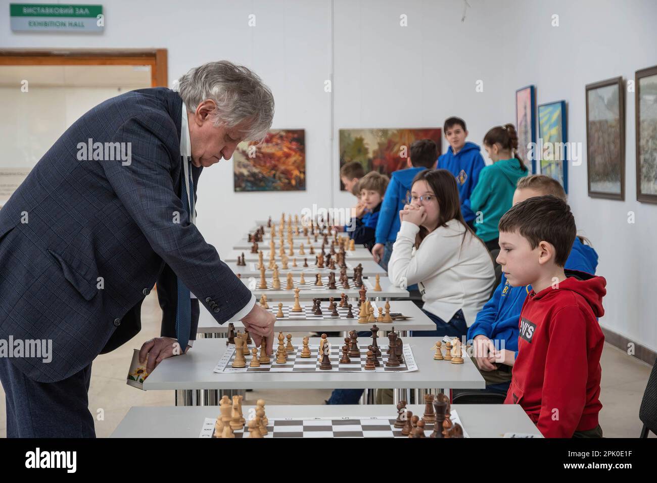 Los niños juegan al ajedrez en una sesión de ajedrez simultánea con el gran maestro  internacional Oleg Romanyshyn. Civiles, militares y niños visitaron una  partida simultánea de ajedrez 'Spring Counteroffensive' con la