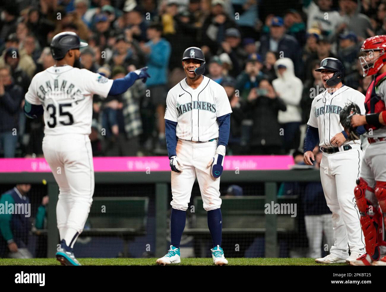 Seattle Mariners' Julio Rodriguez, center, poses for a photo with former  Mariners players Ichiro Suzuki, left, and Edgar Martinez, while holding his  AL Rookie of the Year and Silver Slugger awards, before the team's opening  day baseball game against th