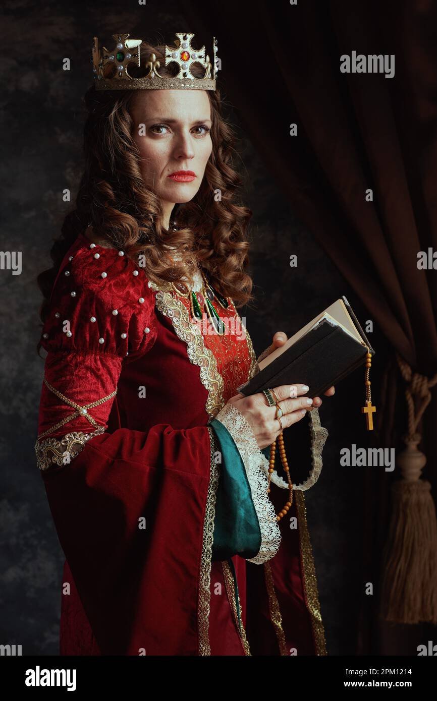 Vamos Compuesto Específico reina medieval en vestido rojo con libro, rosario y corona sobre fondo gris  oscuro Fotografía de stock - Alamy