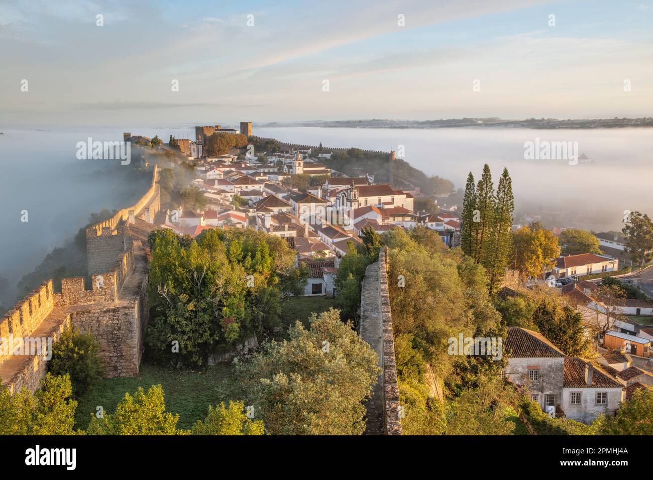 Niebla al amanecer sobre el casco antiguo de Obidos y murallas defensivas, Óbidos, Región Centro, Extremadura, Portugal, Europa Foto de stock