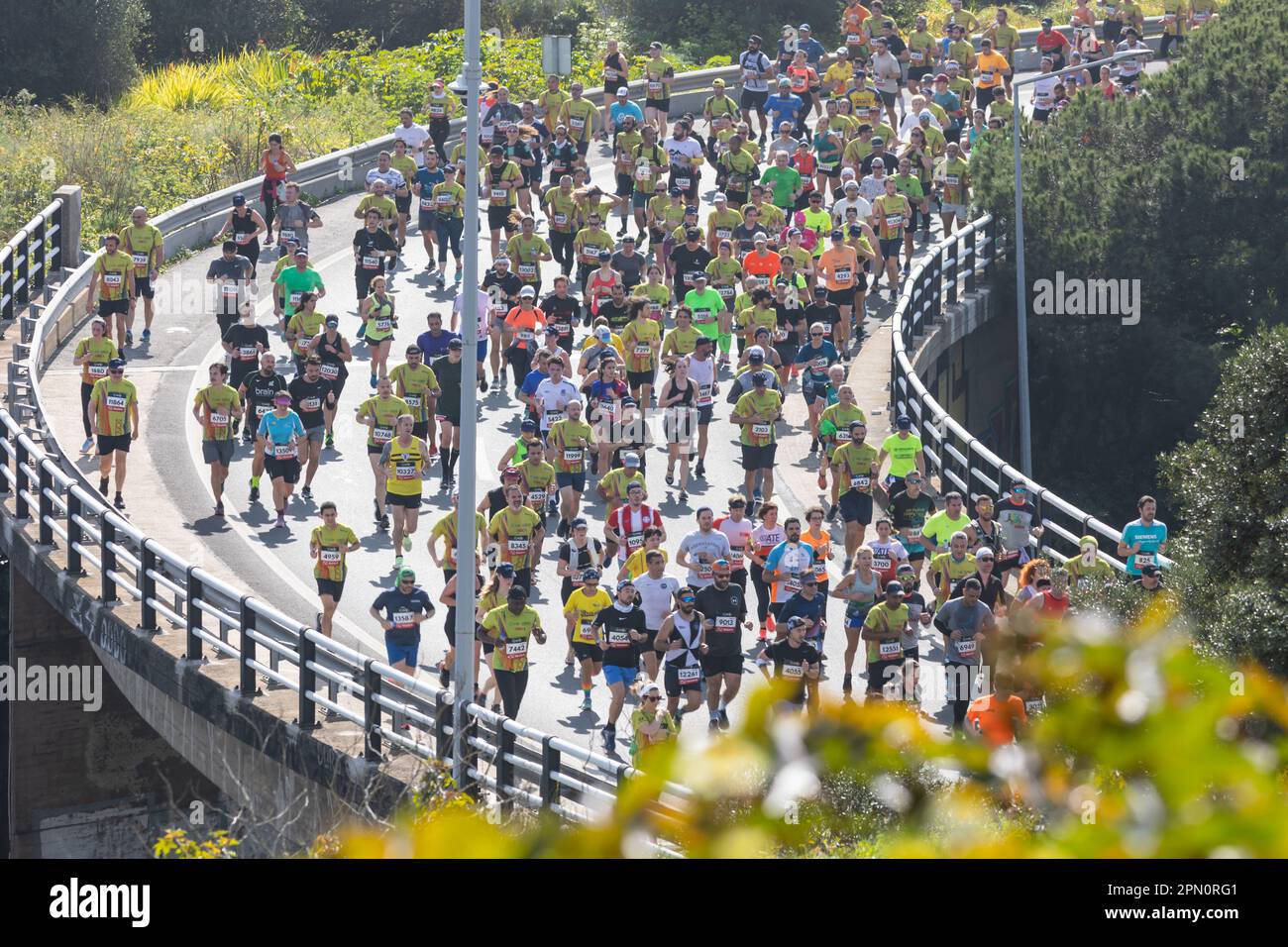12 de marzo de 2023 Lisboa, Portugal: La gente corre un maratón en el puente Foto de stock