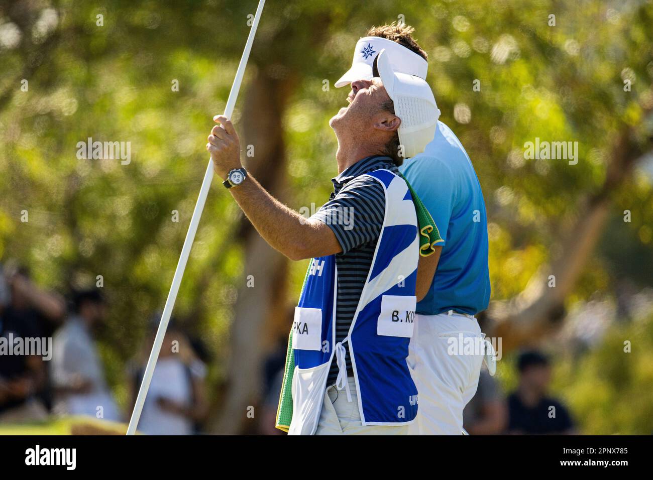 Captain Brooks Koepka of Smash GC caddie, Ricky Elliot laughs on the