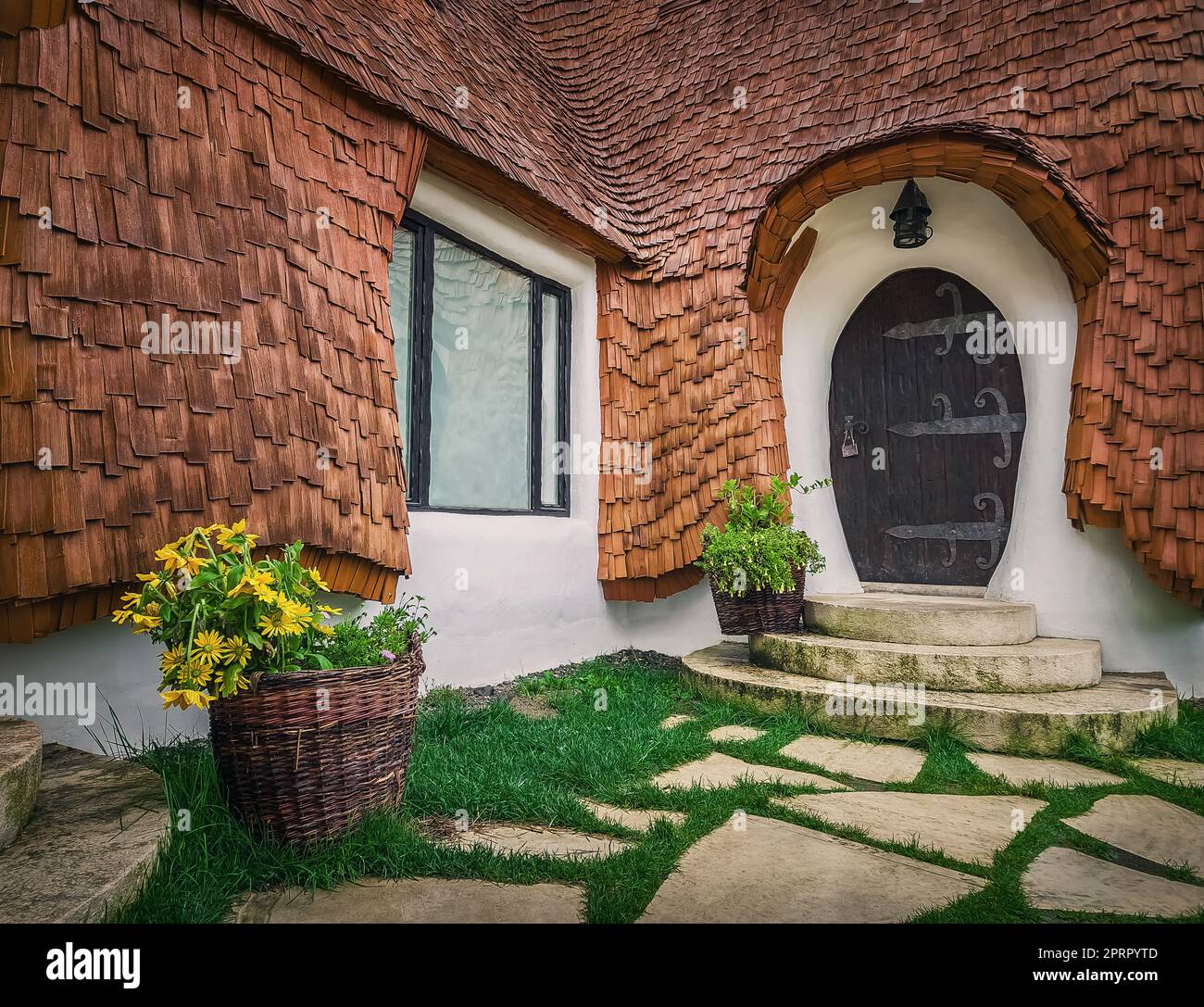 El castillo de arcilla del Valle de las Hadas, un complejo turístico en Transilvania, Rumania. Vista de cerca a una pequeña puerta de entrada, casa enana de fantasía de cuentos Foto de stock