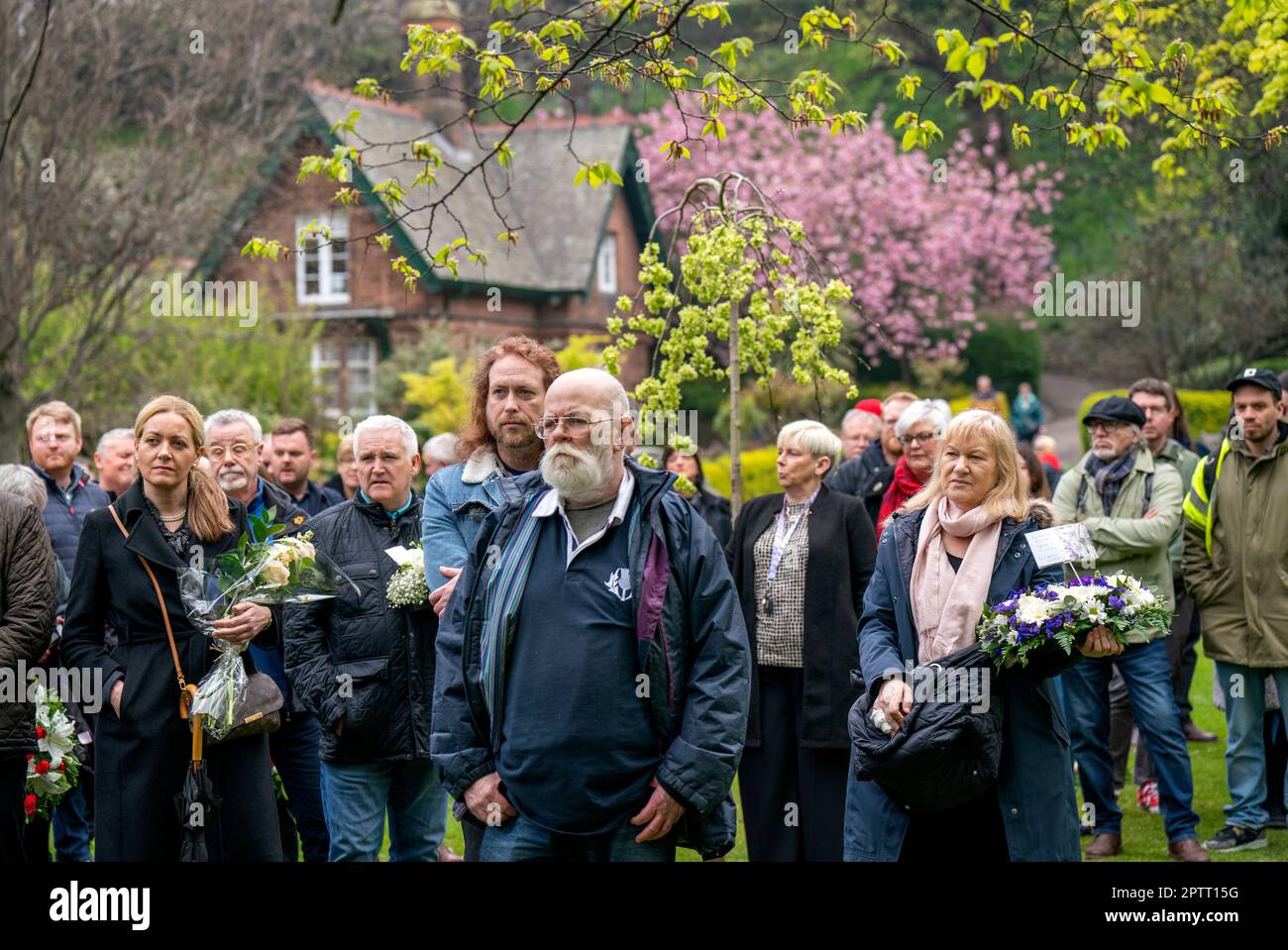 La gente asiste a la conmemoración anual del Día Internacional de los Trabajadores en el árbol conmemorativo en Princes Street Gardens en Edimburgo. Fecha de la fotografía: Jueves 16 de marzo de 2023. Foto de stock