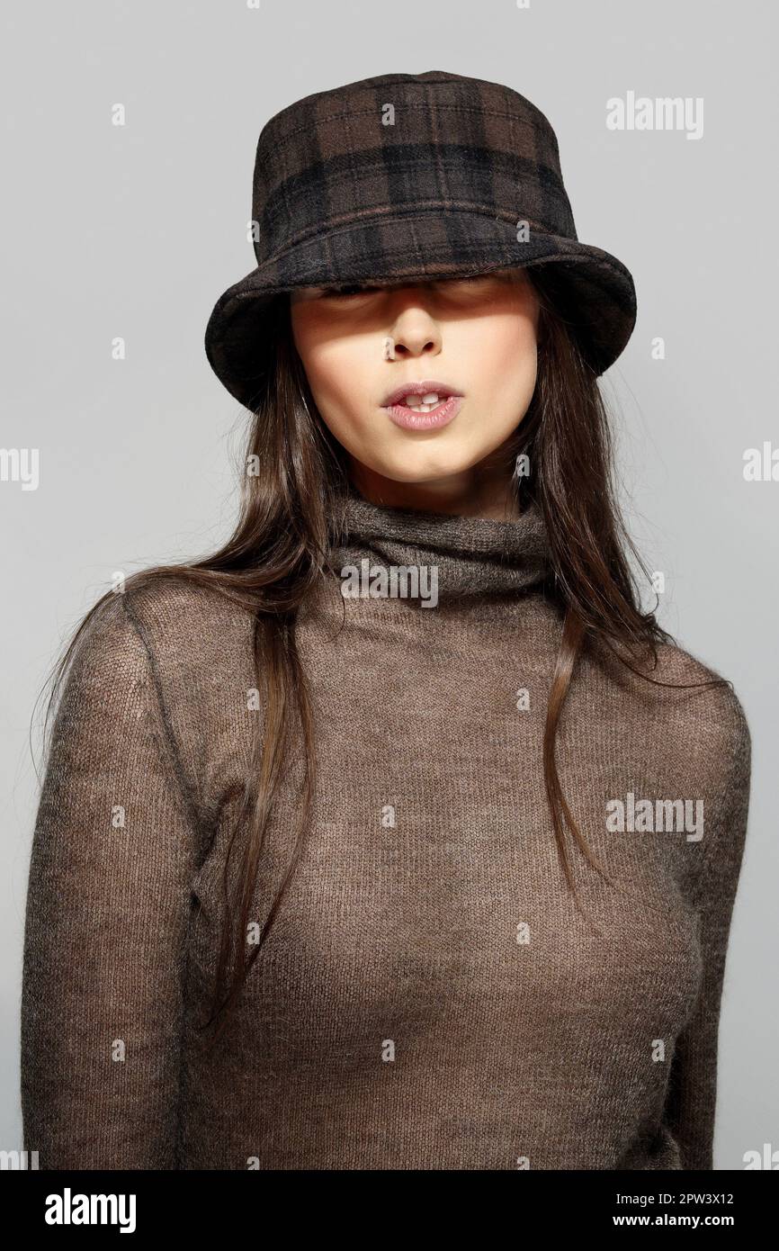 Retrato de la muchacha hermosa en suéter de angora y sombrero en cuadrados Foto de stock