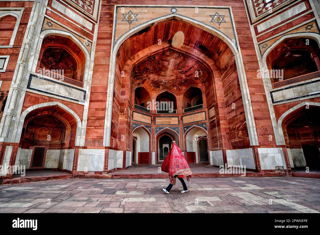 Una persona que lleva un vestido de novia de diseñador camina dentro