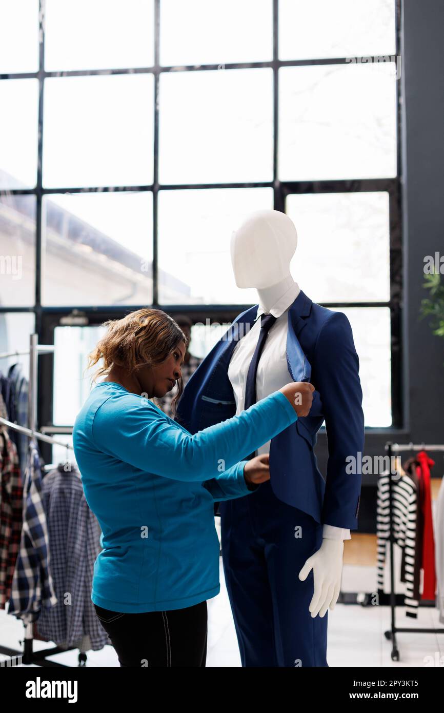 Mujer afroamericana mirando traje formal comprobando el material