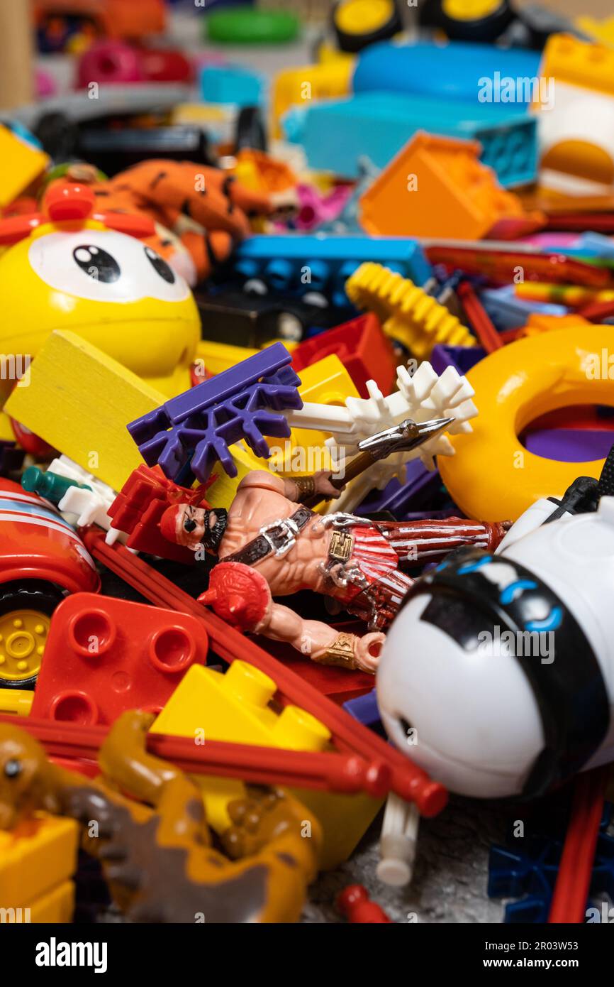Una gran cantidad de juguetes en la habitación de los niños, una gran  cantidad de piezas de plástico multicolor de diseñadores, piezas de  repuesto para juguetes, figuras y cubos Fotografía de stock -