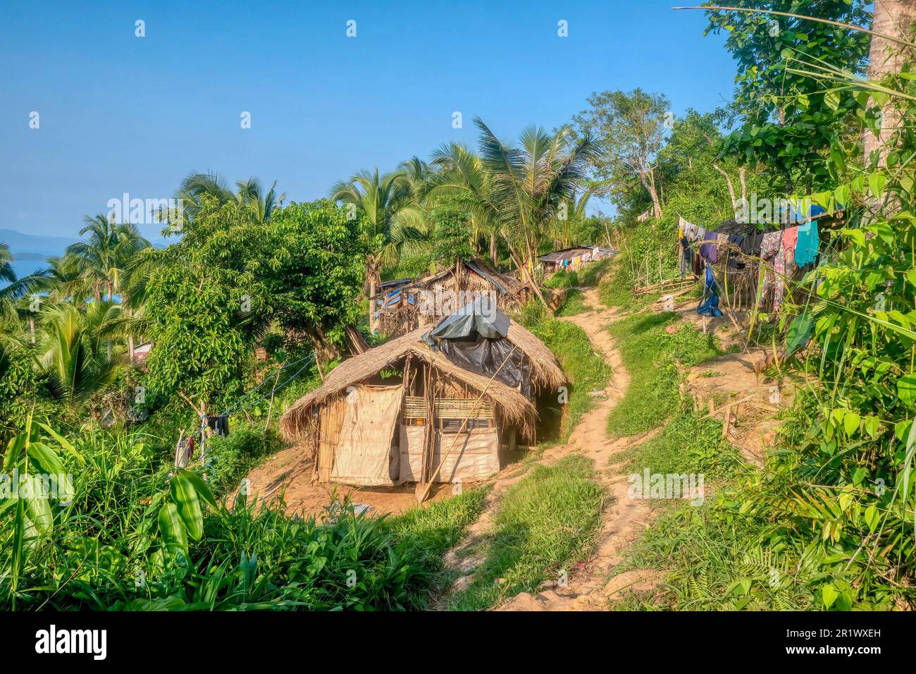 Chozas de paja en una pequeña aldea tribal indígena Mangyan en una colina en la isla de Mindoro, Filipinas. Las casas pequeñas no tienen electricidad ni agua. Foto de stock