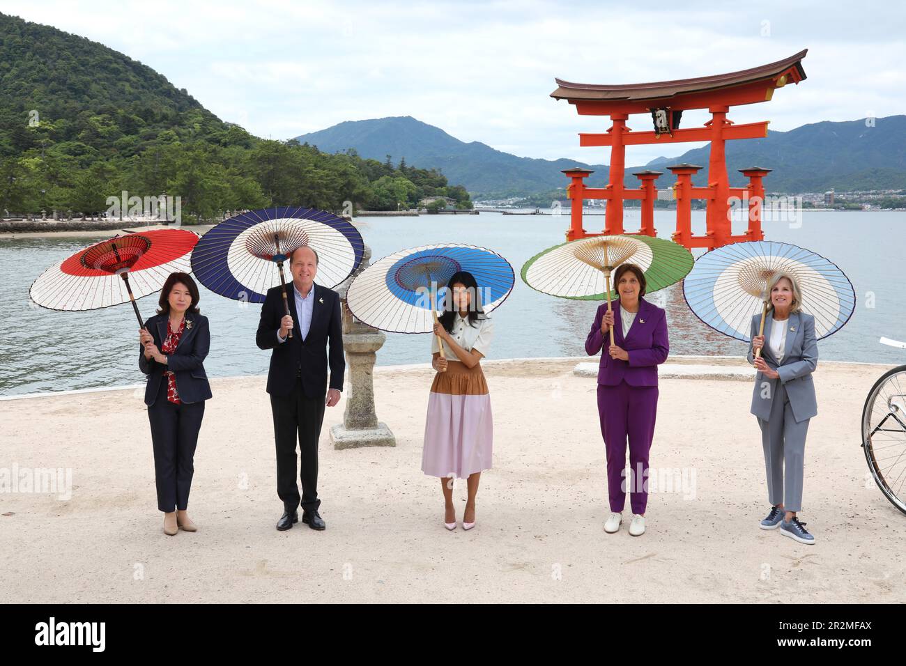 Hatsukaichi, Japón. 20th de mayo de 2023. Los cónyuges del Grupo de los Siete Líderes posan juntos bajo sombrillas de estilo japonés tradicional en el Santuario Itsukushima en la isla Miyajima durante el programa de cónyuges en el marco de la Cumbre del G7, el 20 de mayo de 2023 en Hatsukaichi, Japón. De pie desde la izquierda: Yuko Kishida de Japón, Heiko von der Leyen, esposa del presidente de la Unión Europea, Akshata Narayan Murty del Reino Unido, Britta Ernst de Alemania y la primera dama de los Estados Unidos Jill Biden. Crédito: Pool Photo/G7 Hiroshima/Alamy Live News Foto de stock