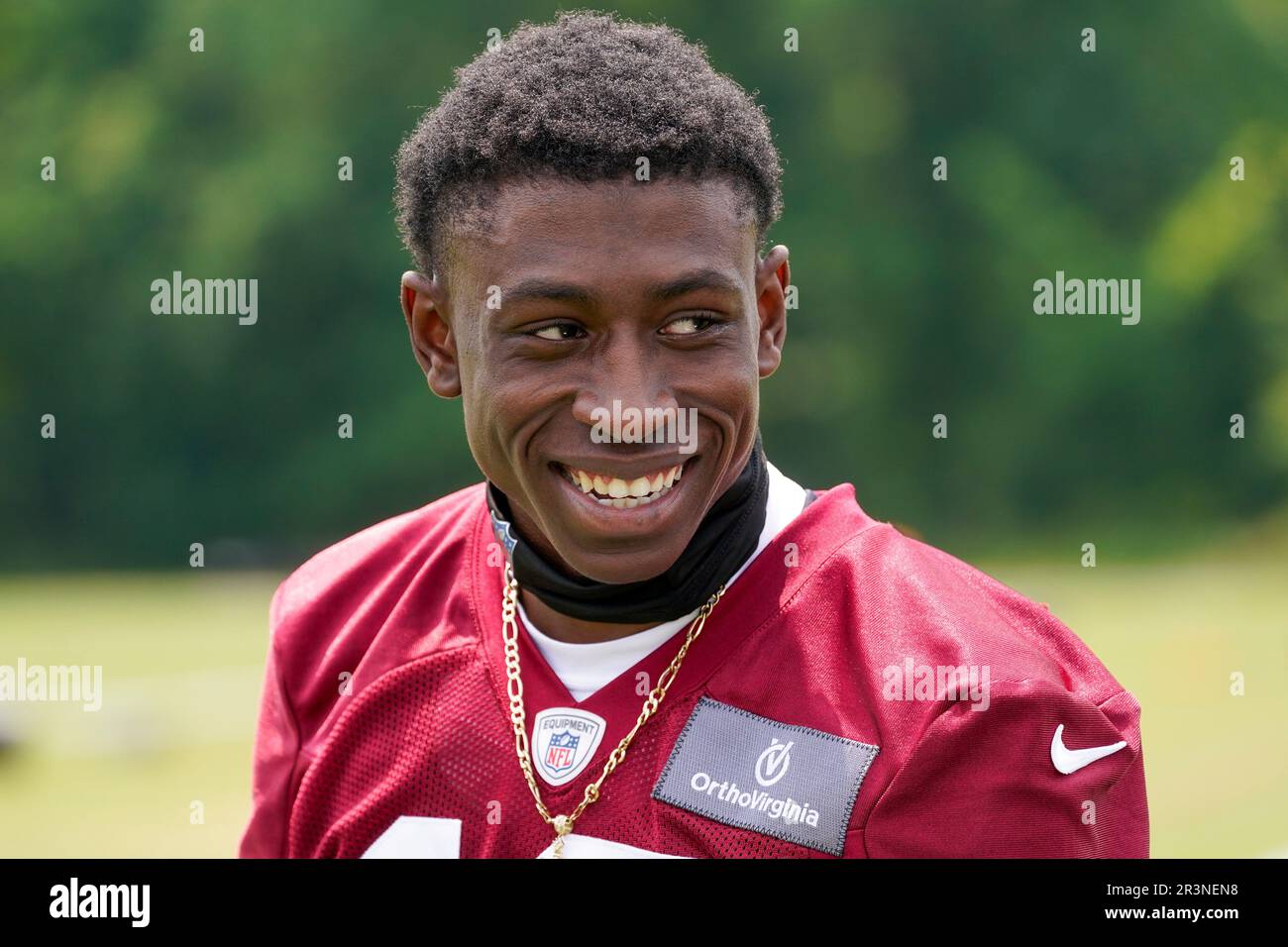Washington Commanders cornerback Emmanuel Forbes (13) smiles after an
