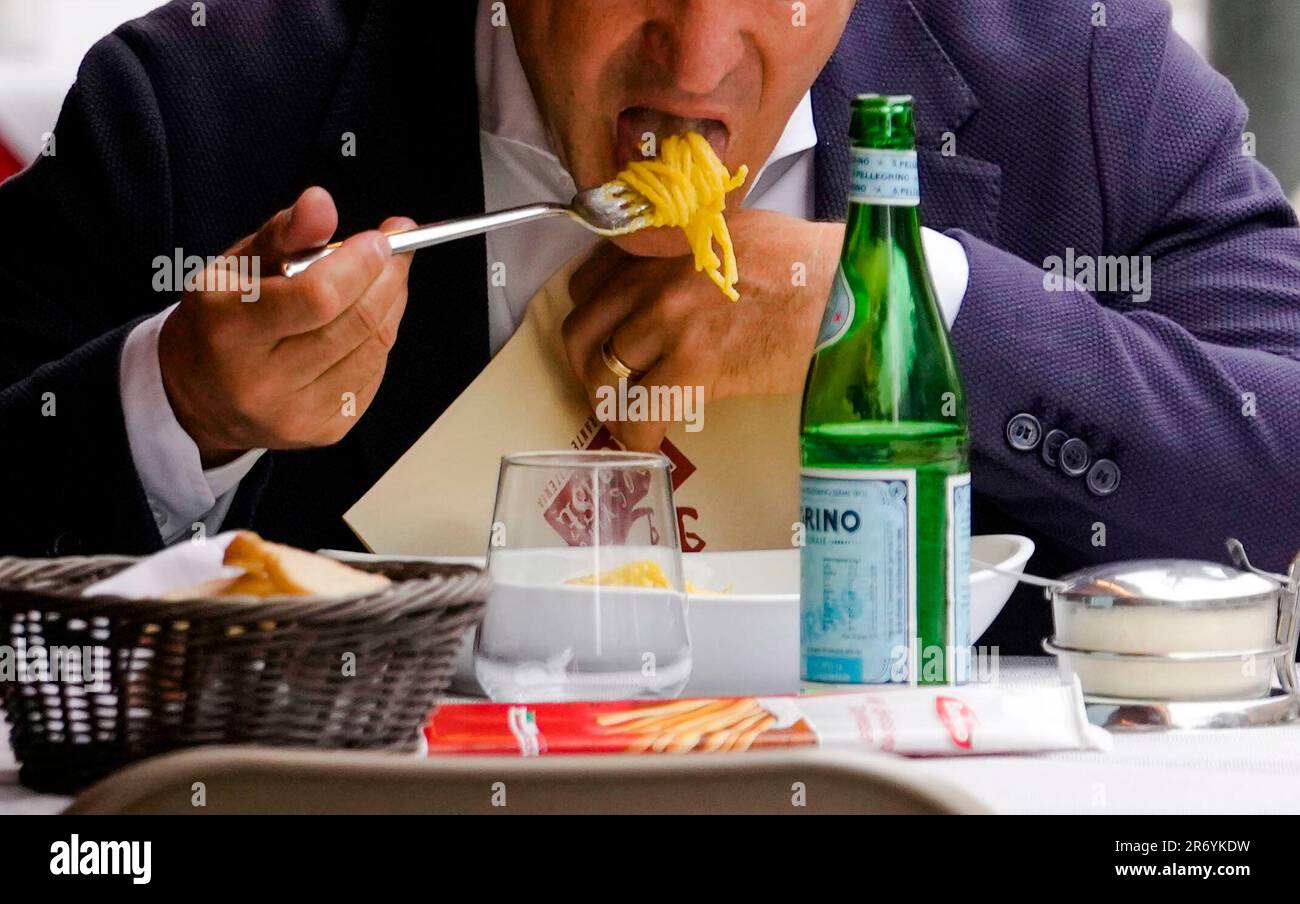 A man eats pasta in a restaurant in Milan, northern Italy, Thursday ...
