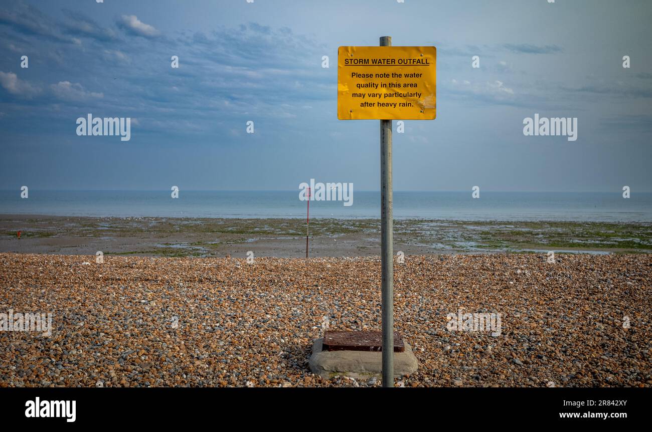 Una señal que advierte a la gente de los peligros del agua contaminada, especialmente después de fuertes lluvias, en la playa de Worthing, West Sussex, Reino Unido. Empresas de agua en t Foto de stock