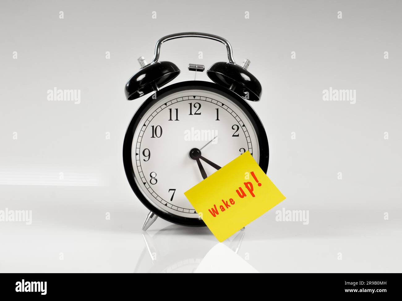 Reloj despertador con un amarillo nota diciendo wake up Fotograf a