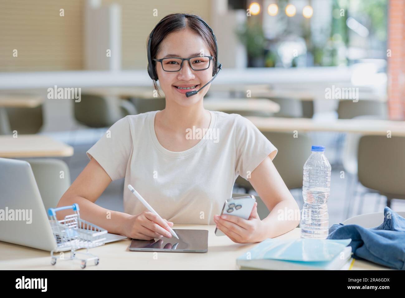 Mujer adolescente universitaria asiática del retrato con la educación del ordenador portátil de los libros que aprende estilo de vida elegante del estudiante. Foto de stock