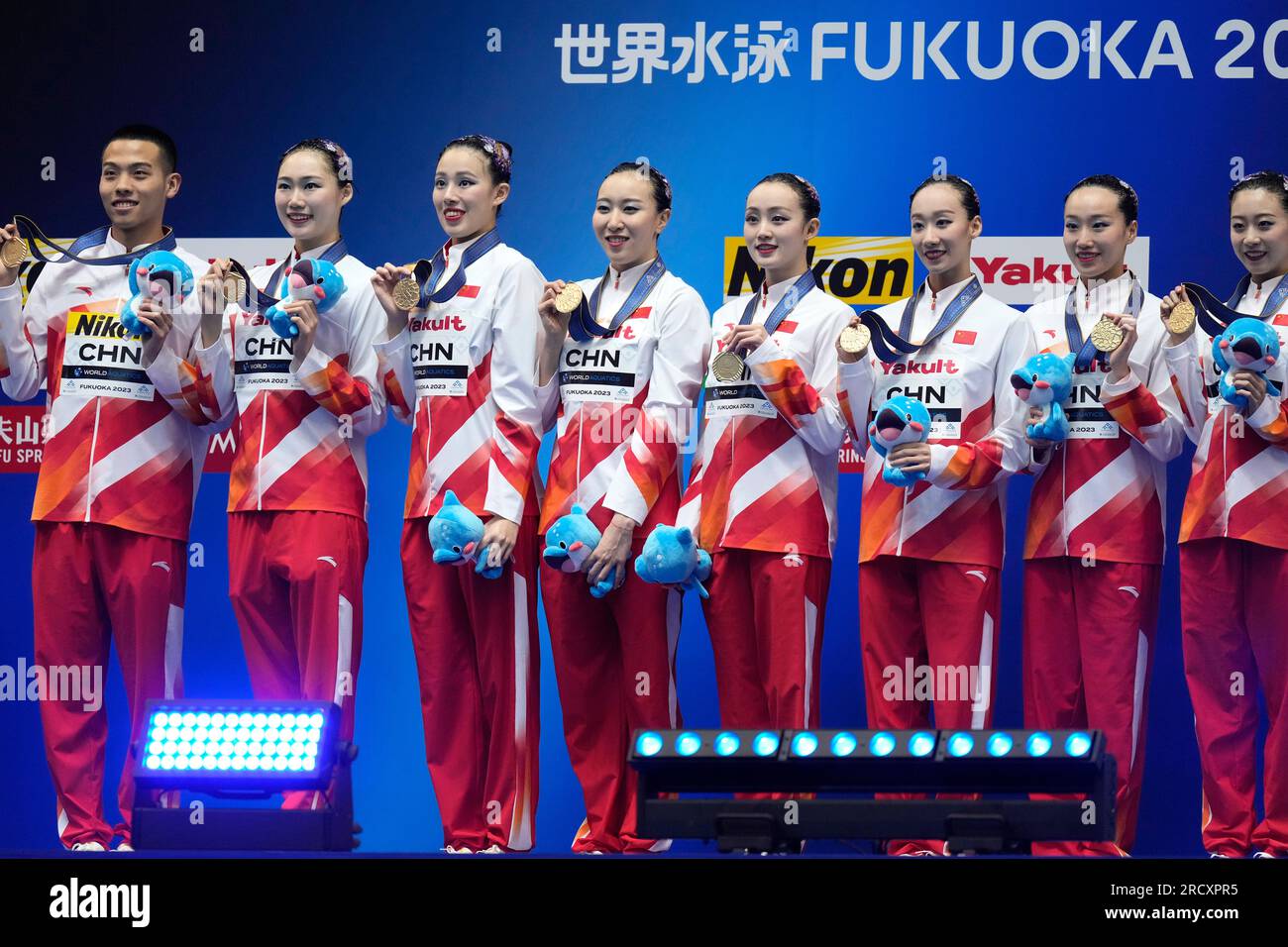 China team members hold up their gold medals after winning the team