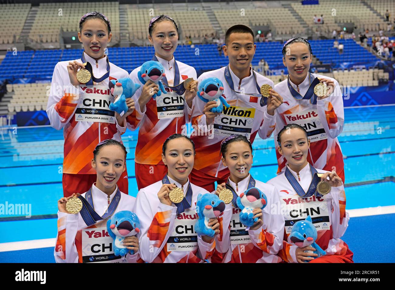 China team members hold up their gold medals after winning the team