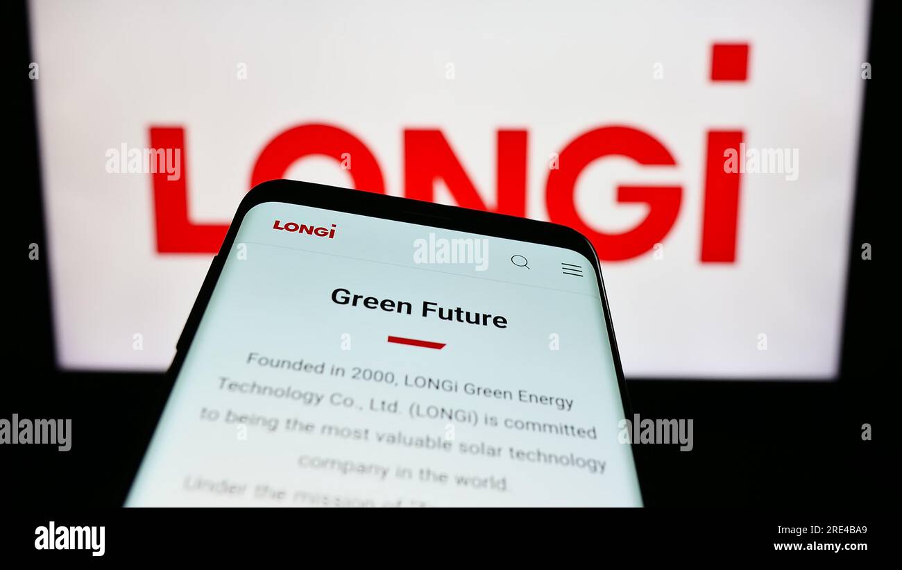 Teléfono móvil con la página web de la compañía longi Green Energy Technology Co. Ltd. En la pantalla delante del logotipo. Enfoque en la parte superior izquierda de la pantalla del teléfono. Foto de stock